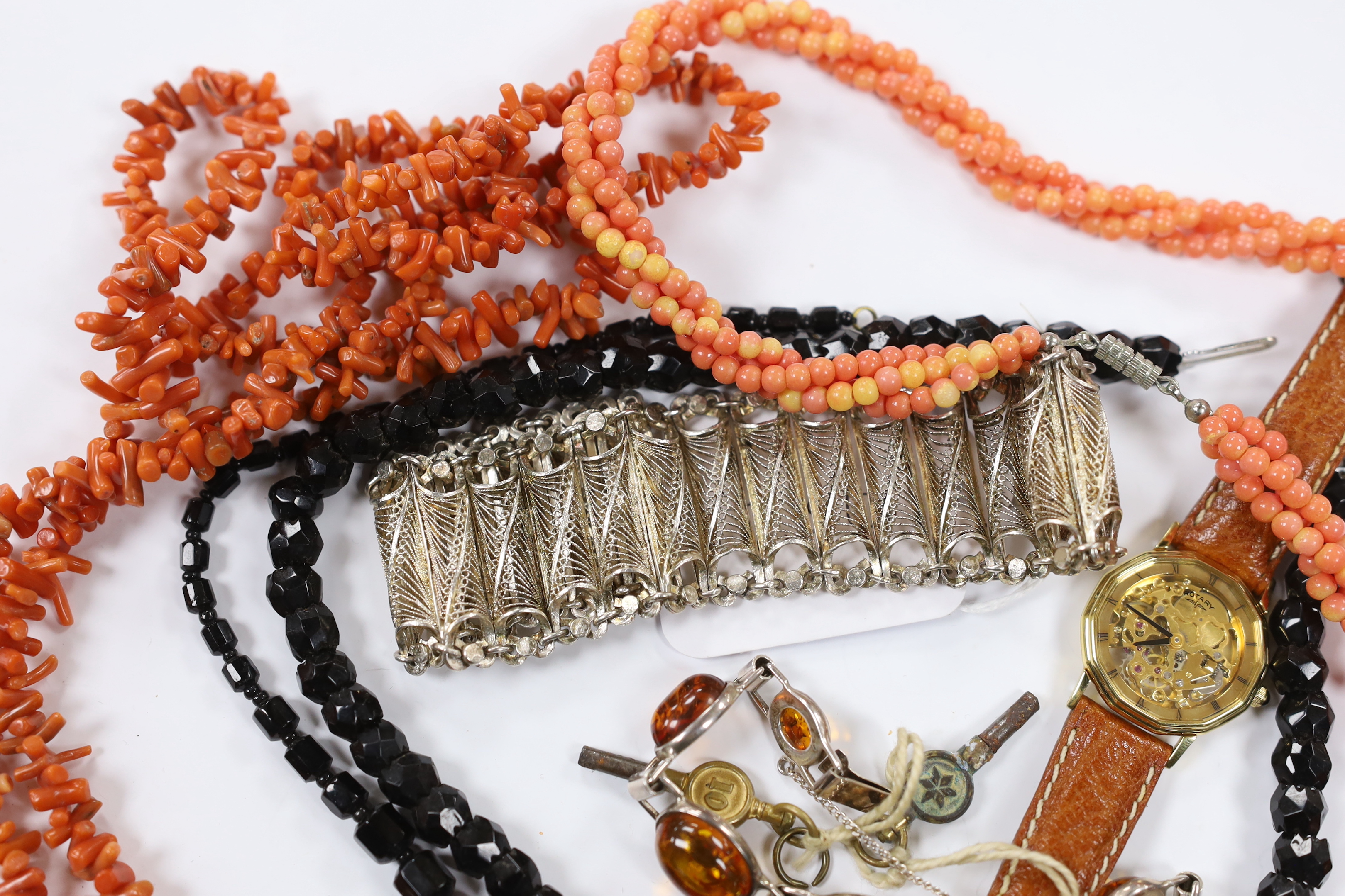 A continental 835 filigree white metal bracelet, a 925 and amber bracelet and other items including a wrist watch and a coral branch necklace.